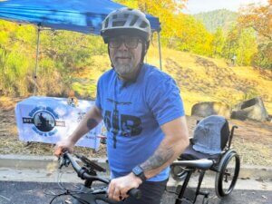 A man on a mountain bike pauses for a photographer.